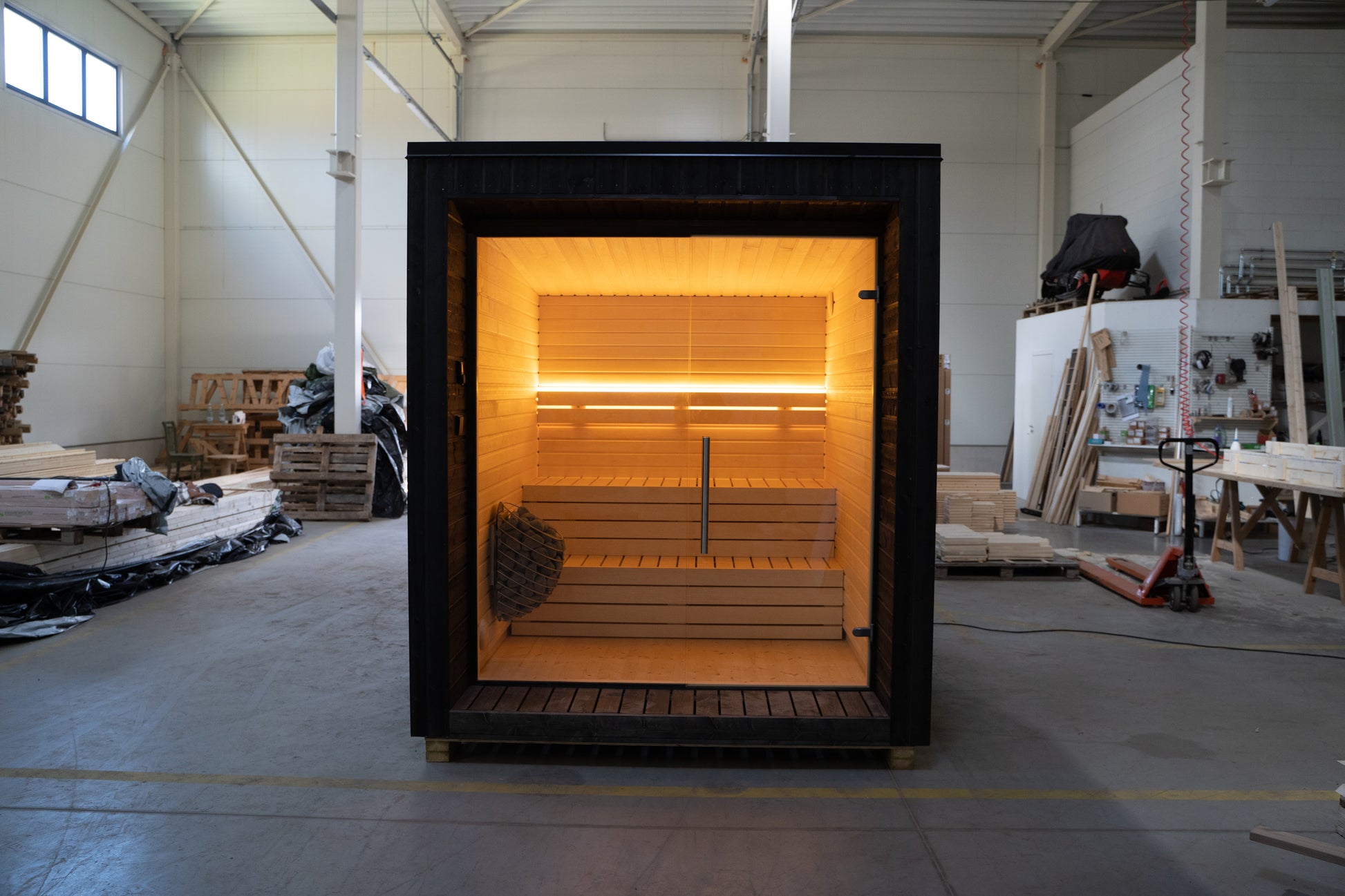 Sauna LUMI con pared de cristal en el interior.