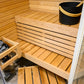 Sauna Sirius Corner con bancos de madera y cubo negro.