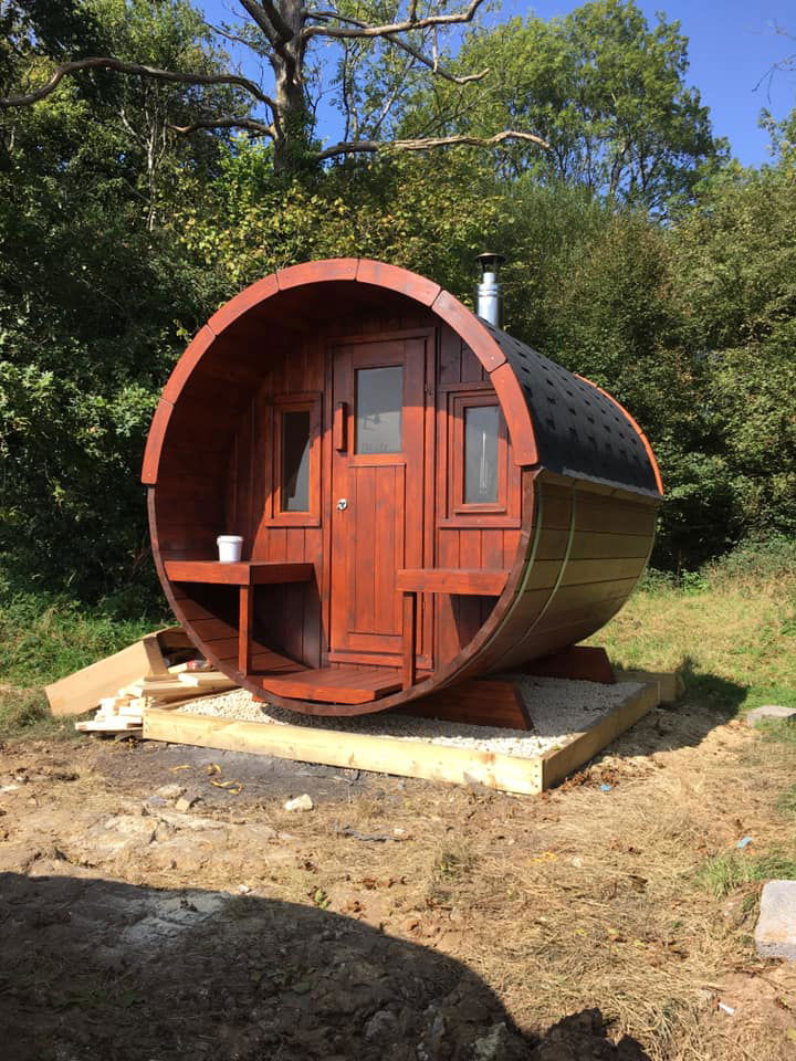 Saunamo Sauna exterior Barrel 235 con diseño cilíndrico y terraza integrada.